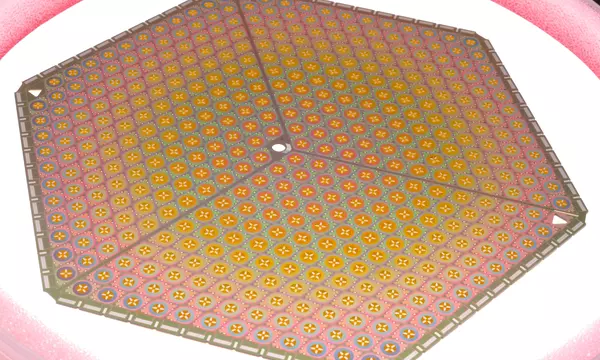 Six-sided metallic plate has rows of pinkish sensors.